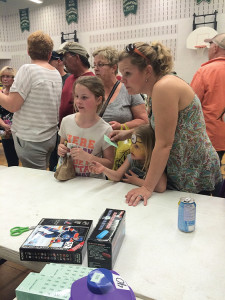 The Coe family looks on anxiously as tickets are drawn for the kids' prizes. MELISSA ARMSTRONG Staff