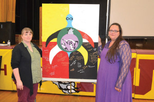 Teacher Heather Taylor and Marsha Depotier of the Metis Nation of Ontario show the banner of support from NHHS, which will be sent to the Attawapiskat community. TONY PEARSON Special to This Week